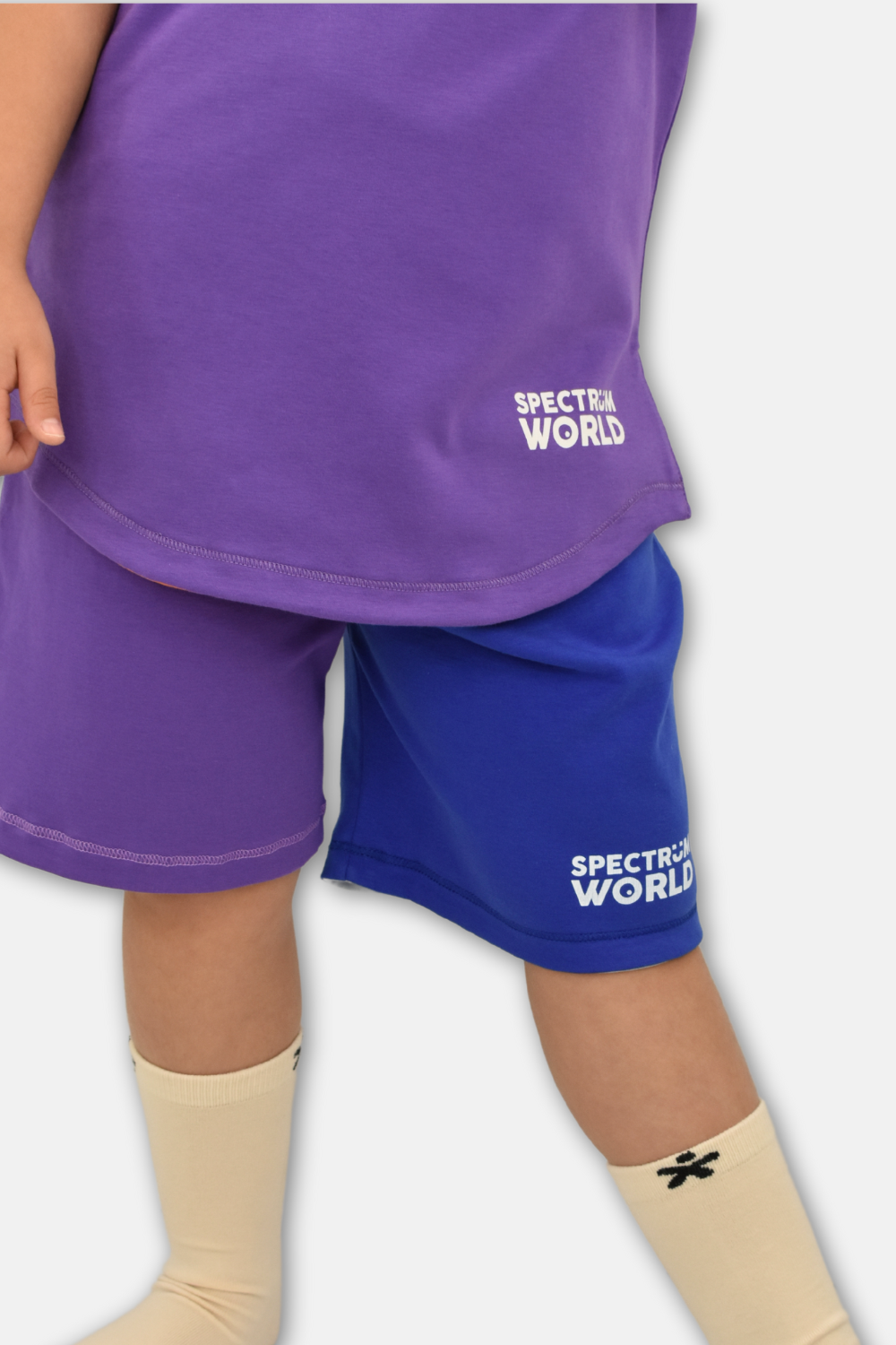 Child wearing reversible sensory-friendly shorts in Peruvian cotton.